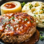 Salisbury steak with ground chicken served with mushroom gravy and mashed potatoes.